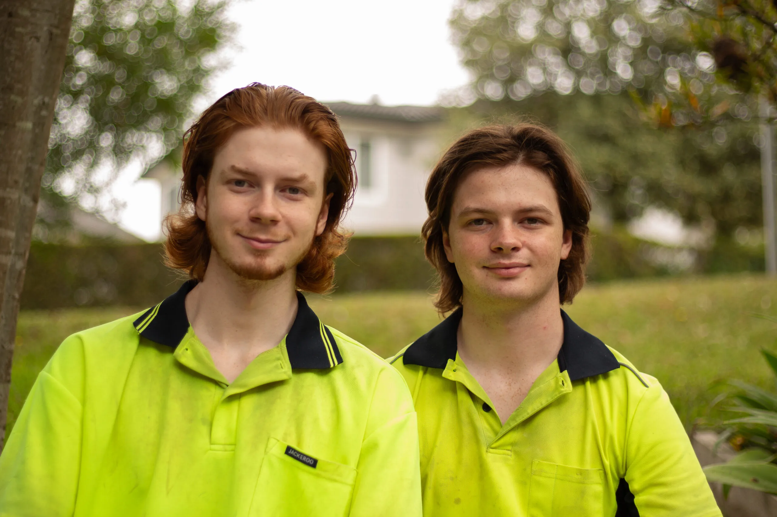 Two Young Brothers standing next to each other smiling